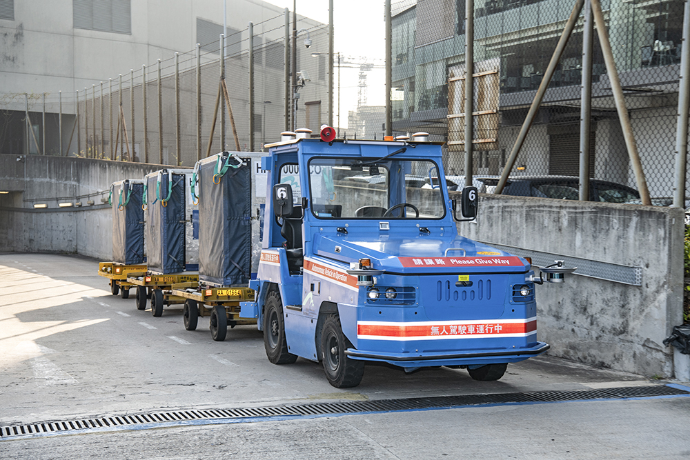 Autonomous electric tractor was departing from the SkyPier and heading towards the Baggage Hall at Terminal 1.
